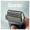 Sonic electric shaver held by a hand with a clear background