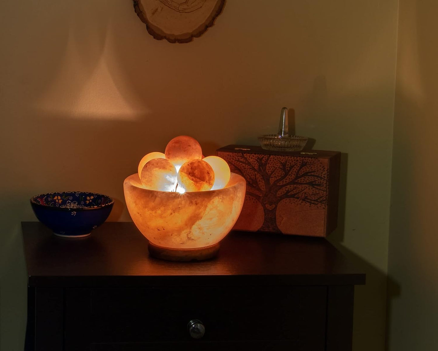 Decorative lamp with glowing interior on a wooden surface