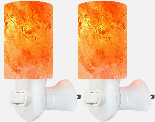 Two orange cylindrical night lights on white background