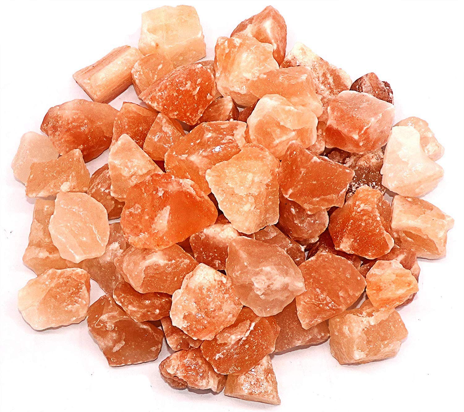 Heap of orange crystal rocks on a white background