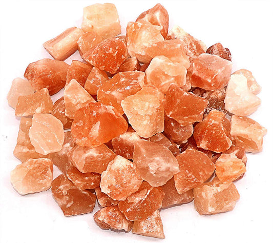 Heap of orange crystal rocks on a white background
