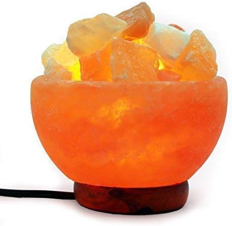 Himalayan salt lamp with visible crystals on a white background