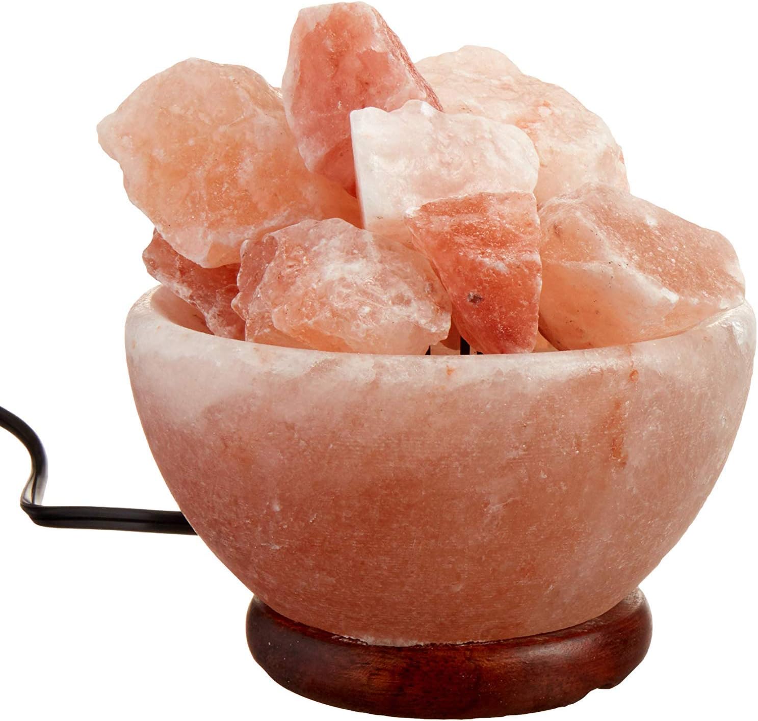 Himalayan pink salt crystal bowl with wooden base on a white background