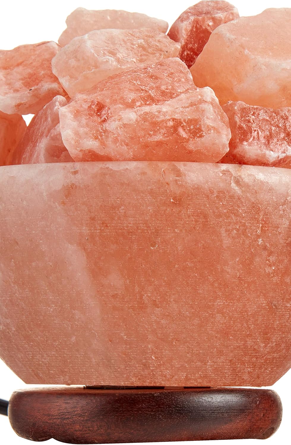Close-up of pink Himalayan salt blocks with a wooden holder on a white background