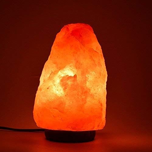 Himalayan salt lamp emitting a warm glow on a dark background