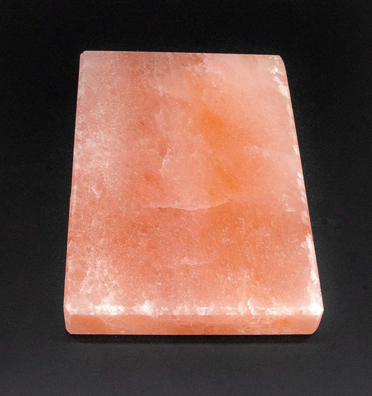 Rectangular pink crystal block on a black background