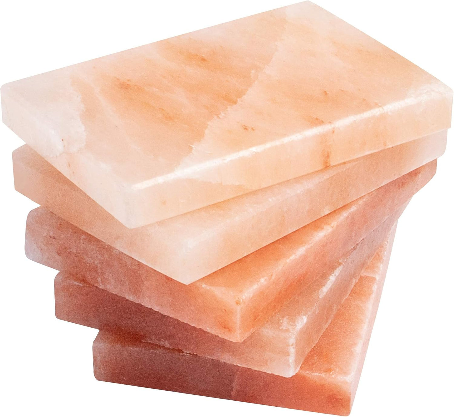 Stack of pink Himalayan salt blocks on a white background